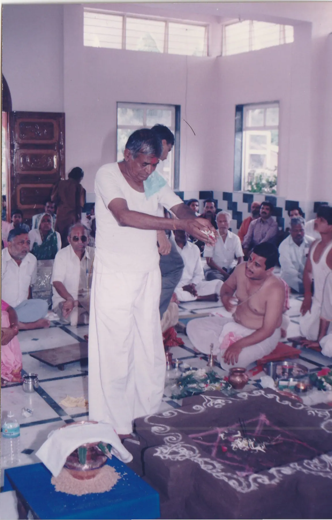 Param Pujya Shri Dhondiram Baba Chavan standing during a ritual gathering with devotees