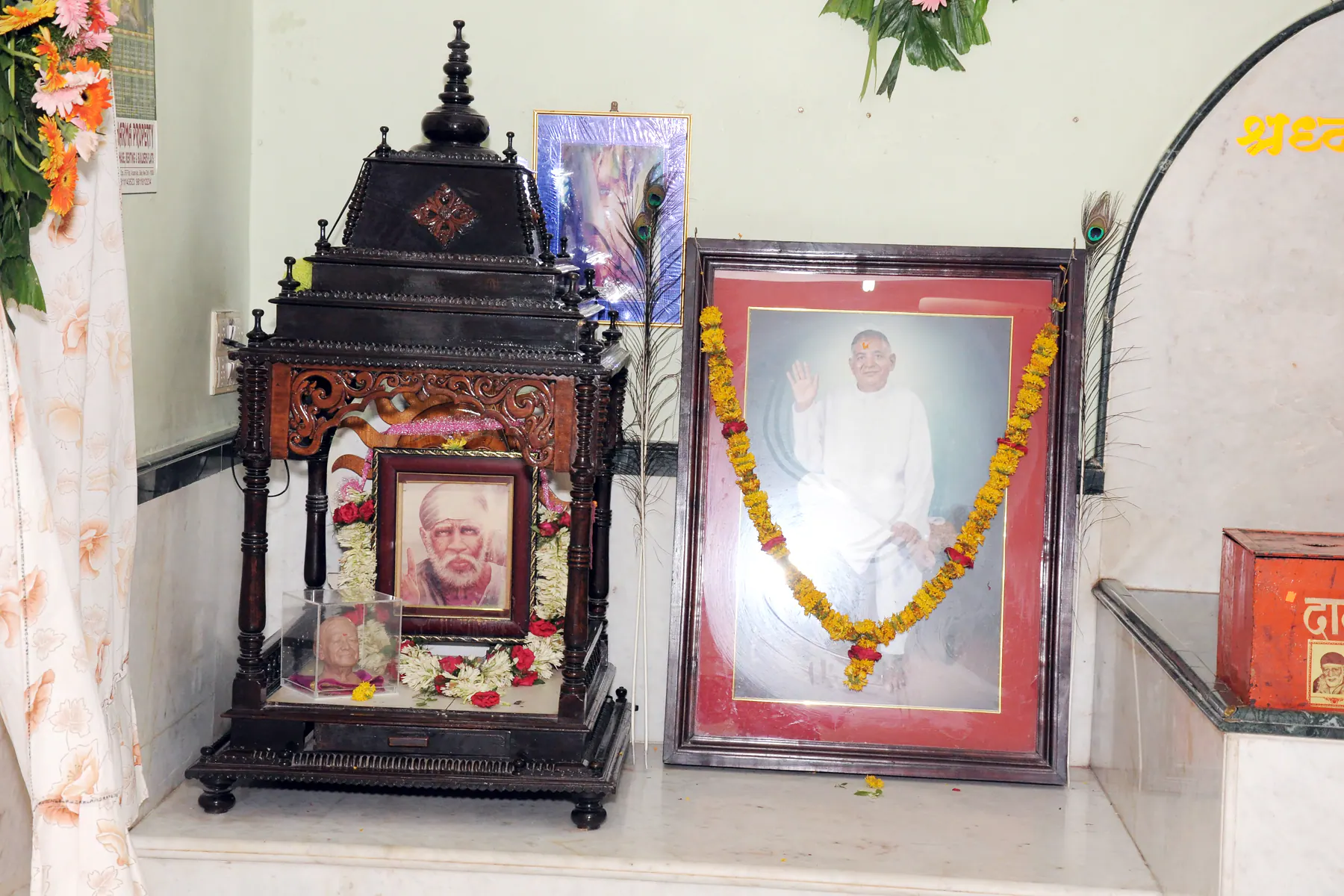 Framed photo of Param Pujya Shri Dhondiram Baba Chavan beside a carved shrine inside Gurusthan