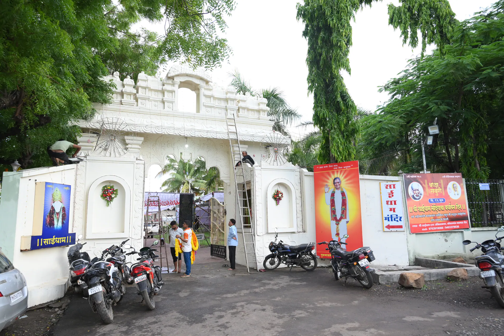 Saidham Mandir entrance gate shaded by trees