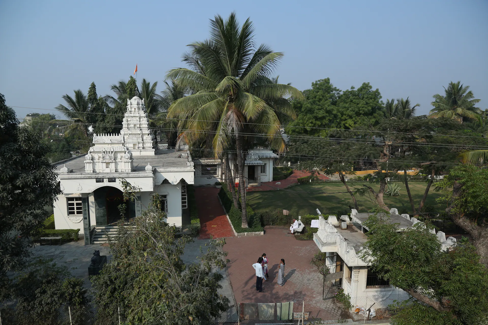 Elevated view of the Saidham Mandir campus with temple structures and trees